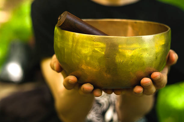 hands holding a tibetan wold, horizontal imagel, exteriors.